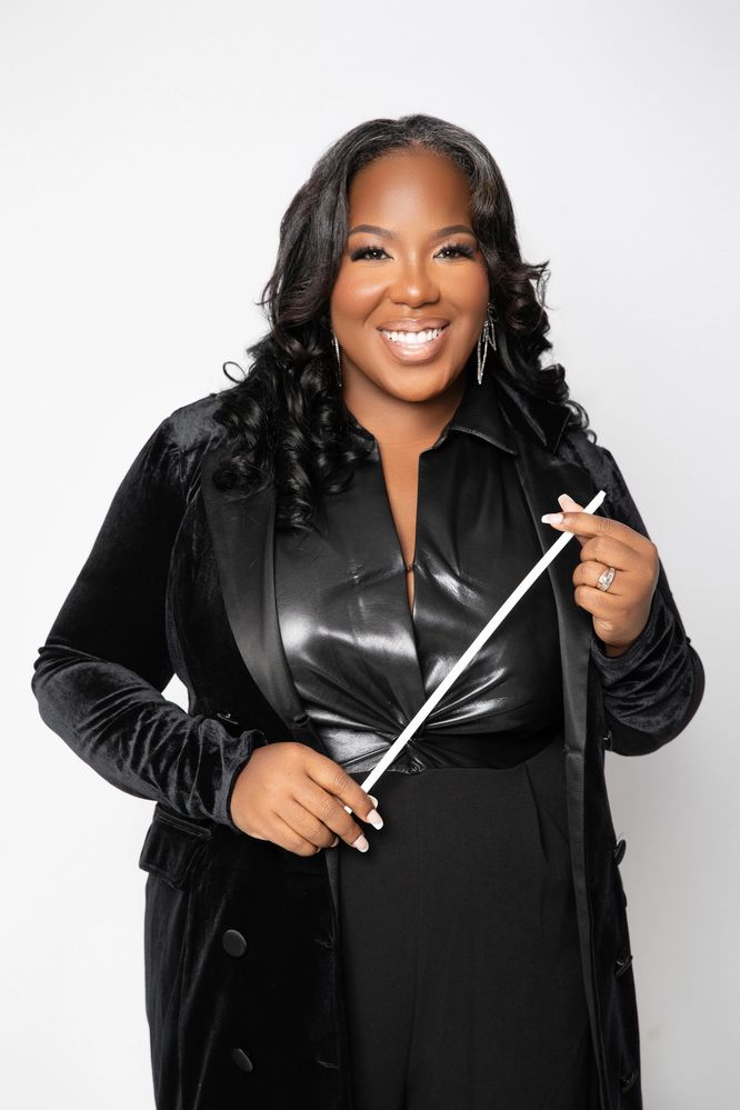 Picture of Maria A. Ellis holding conducting baton and smiling 