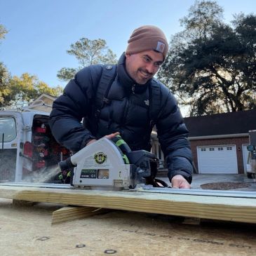 Man cutting wood with a circular saw.