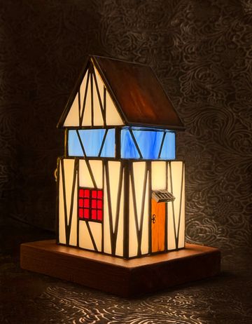 Illuminated stained glass house lamp.