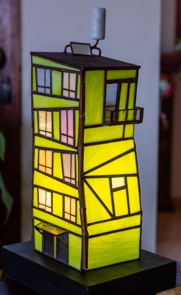 Stained glass lamp shaped like a house.