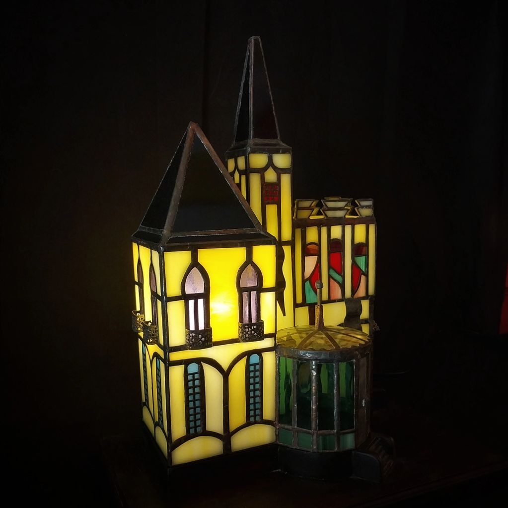 Stained glass lamp shaped like a gothic building.