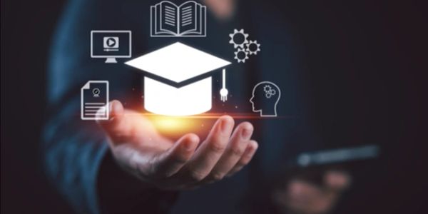 Hand holding digital education icons.