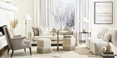 Elegant neutral-toned living room with cozy seating and minimalist decor.
