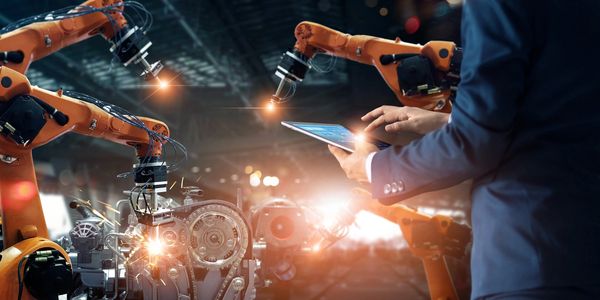 A man controlling robots with a tablet