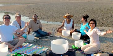 Group sound bath on the beach