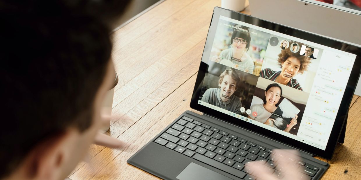 Group of English students talking to each other over Zoom or Teams  seen on computer of one of them