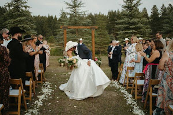 Bride and groom mid aisle kiss dip