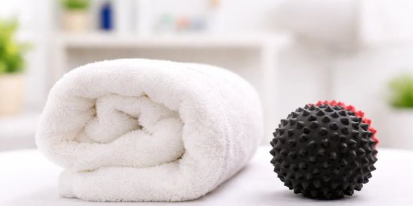 White towel and black spiky massage ball.
