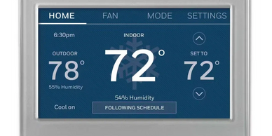Digital thermostat displaying indoor temperature and settings.