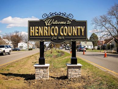 Welcome sign for Henrico County, established 1611, on a suburban road.