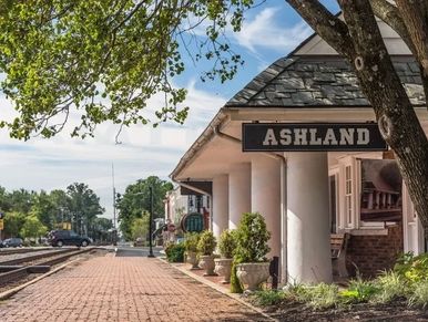 Historic Ashland train station with columns and brick platform.