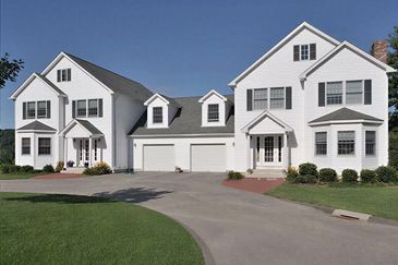 Row of white attached townhomes.
