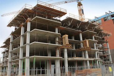 Large concrete building under construction.