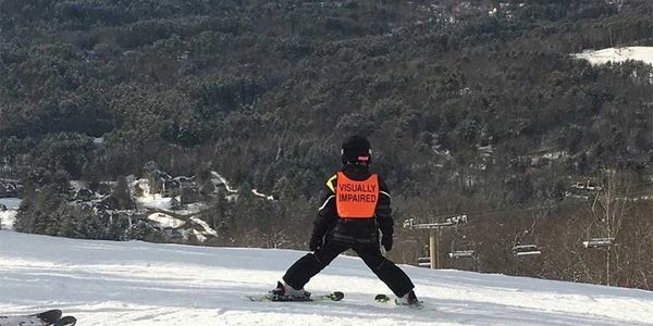 blind skier starting to go down an open slope