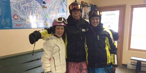 Two ski Instructors with students in office