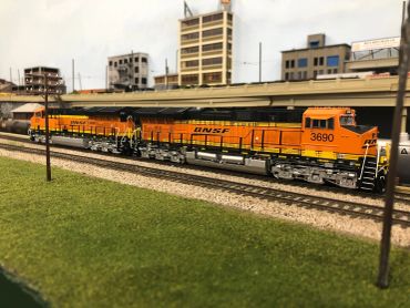 Model train set with cityscape background.