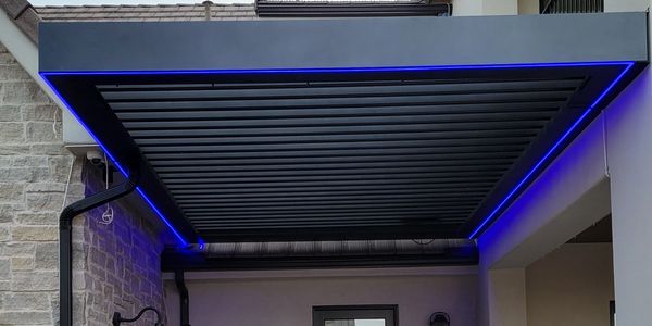 Custom color changing tape lighting, installed under an outdoor pergola