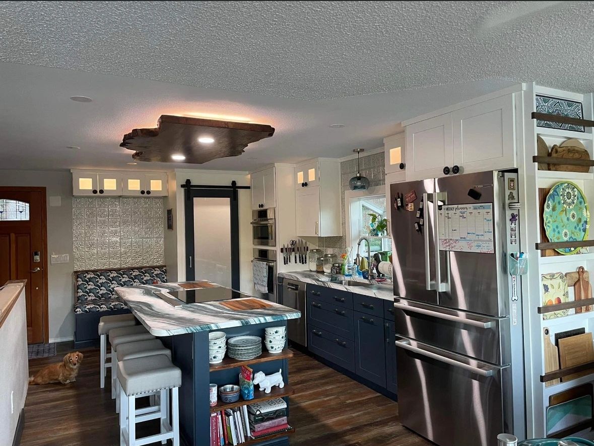 Kitchen Remodel with cabinet lighting, center island lighting, and a cooktop.