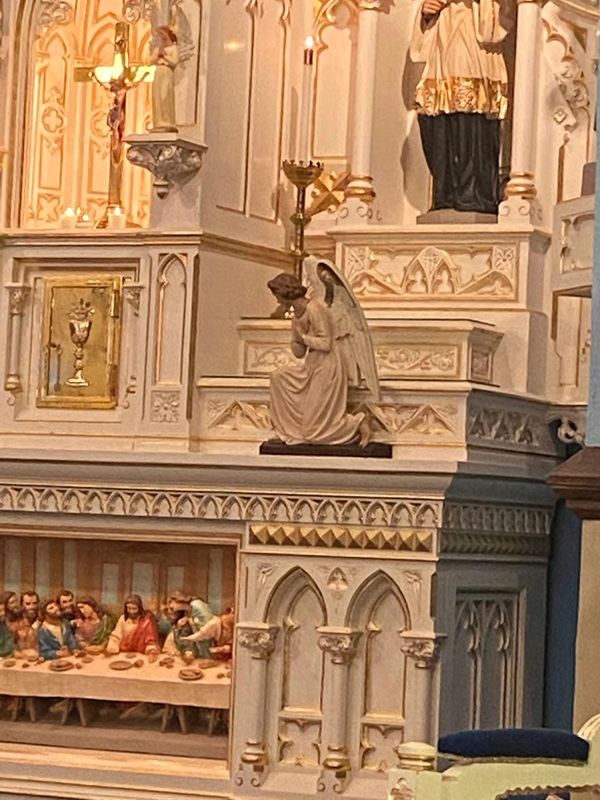 Image of the inside of St. Mary's Catholic Church looking at the Altar's last supper and angel. 