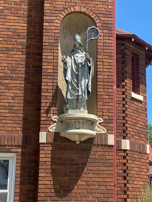 Image of the outside of St. Patrick's Catholic Church looking at the statue of St. Patrick. 
