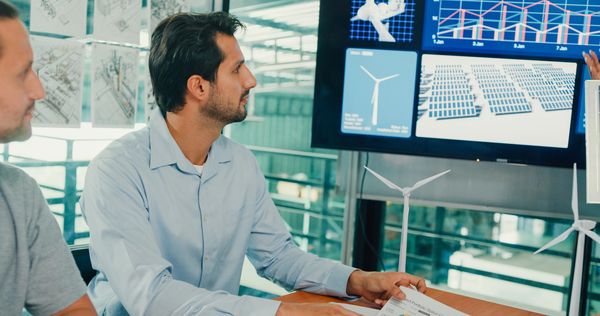 Engineers discuss solar and wind power data.