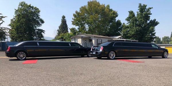 The twin limos with the red carpet rolled out