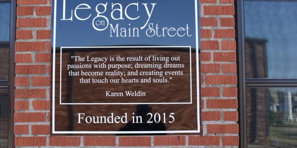 Sign for Legacy on Main Street with an inspirational quote by Karen Weldin.