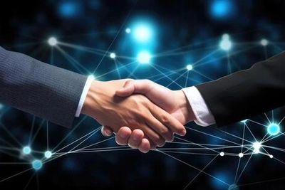 Two people in business suits shaking hands with a digital network background.