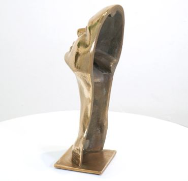 Abstract bronze sculpture of a human head and neck, hollow and standing on a square base.