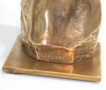 Close-up of a bronze sculpture base signed 'DEL PORTE' and numbered 34/100.