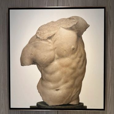 Ancient marble torso sculpture showcasing detailed musculature.