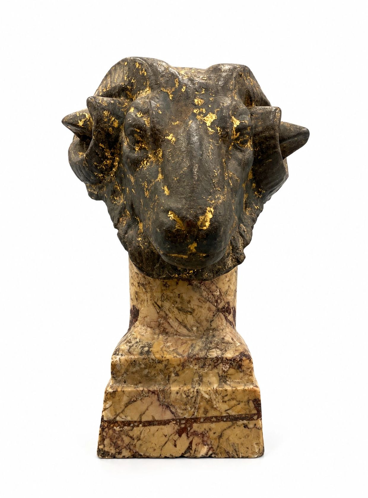 Decorative ram head sculpture with gold accents on a marble base.