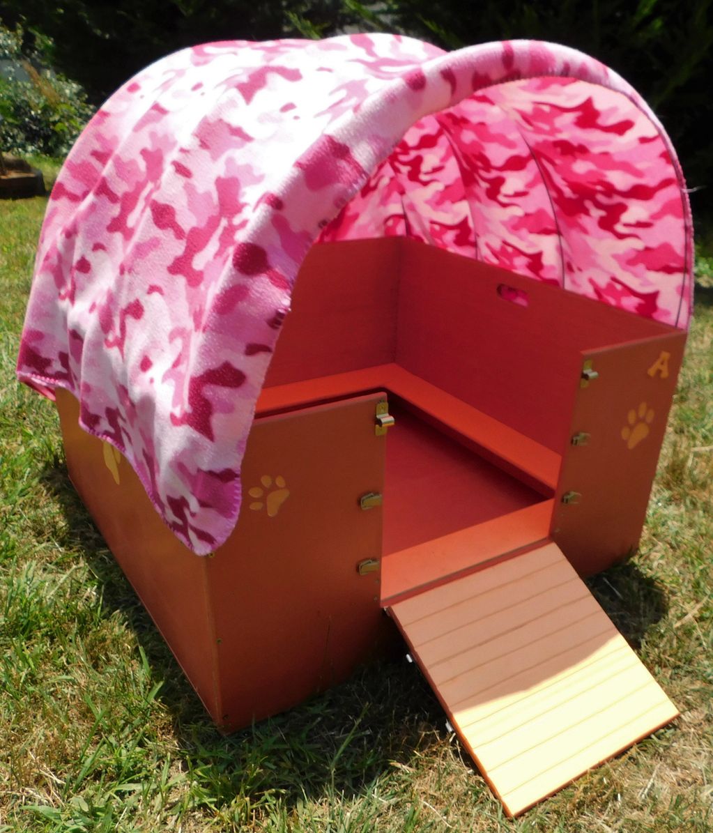 A Shih Tzu whelping box with a wagon style covered roof.