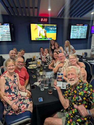 Group of adults enjoying a social gathering at a bar or restaurant.