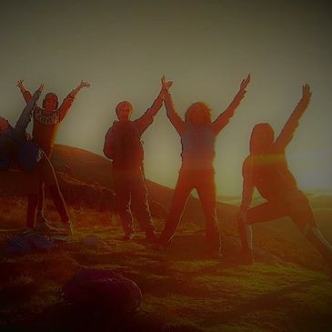 People celebrating the sunrise on a mountain top