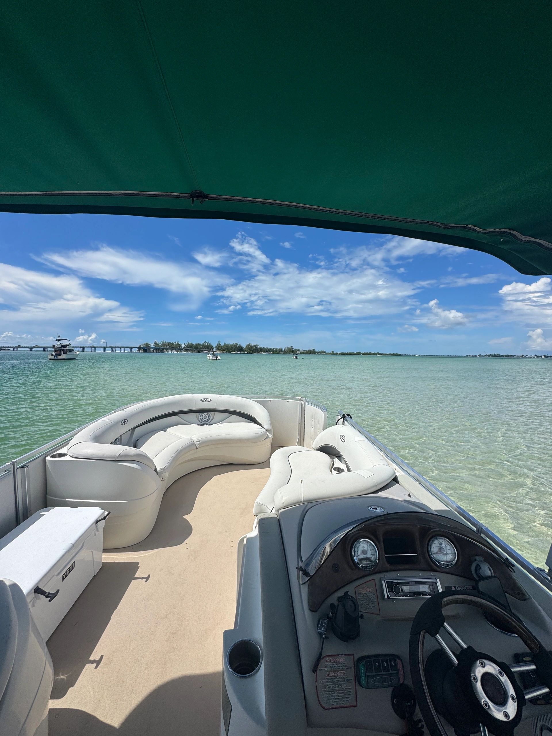 View from a boat with clear waters and blue sky.