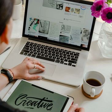 Creative Digital Marketer for Artisans Working on Tablet and Laptop