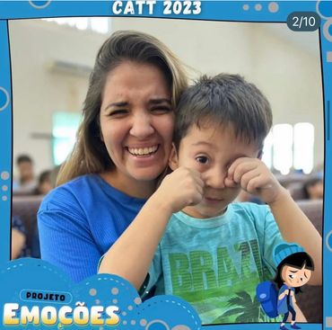 Smiling woman with a child rubbing his eyes at an event frame.