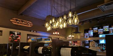 Display of wine bottles used as divider from Capone’s Bar and Dining area