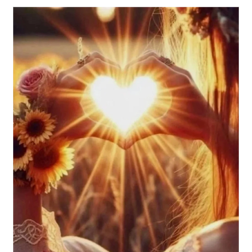 Hands form a heart shape with sunlight shining through.