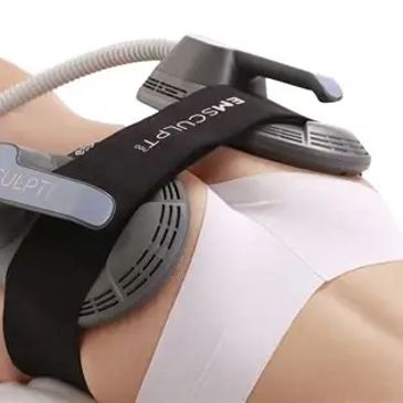 A person undergoing EMSculpt body contouring treatment on the abdomen.