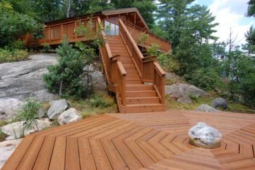 Restored Muskoka deck with stairs featuring professional media blasting and premium stain finish.