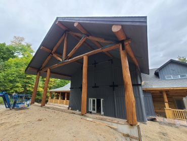 Restored Muskoka timber structure with large wood beams professionally media blasted and stained for long-lasting protection.