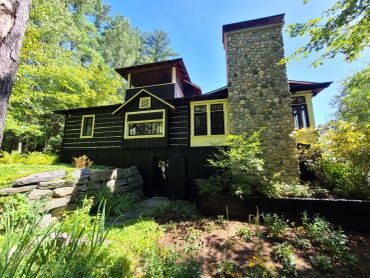 Restored Muskoka log home with professional media blasting and premium stain finish, chinking