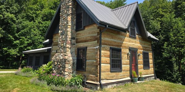 Log Home Restoration in Ontario- Wood restoration power washing and sealed with Sansin, caulking Log