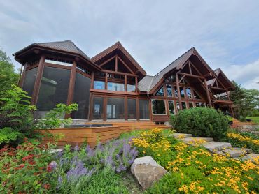 Restored Muskoka log home with professional media blasting and premium stain finish.