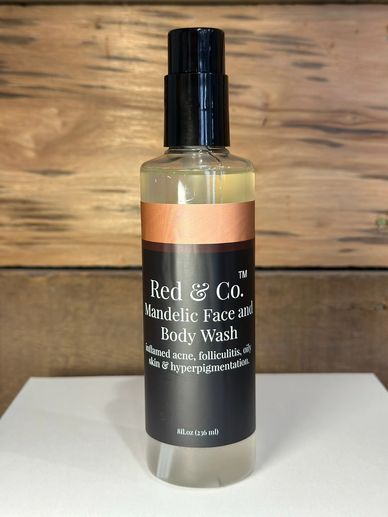 Bottle of Red &amp; Co. Mandelic Face and Body Wash on a white surface.