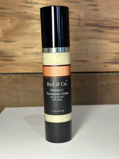 Bottle of Red &amp; Co. Vitamin C Treatment Cream for skin protection and anti-aging.