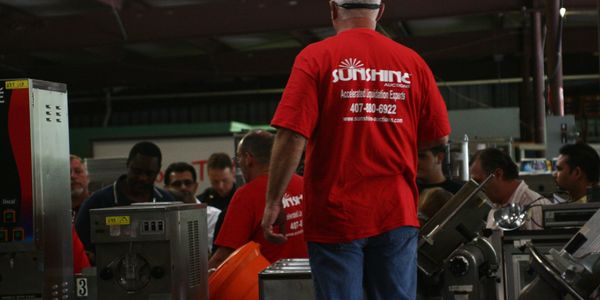 A colorful sunset over a calm lake, with silhouettes of trees and mountains reflecting in the water.