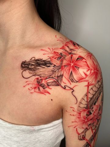 Dragon tattoo red ink Asian style fine line hand drawn design on shoulder floral petite lilies